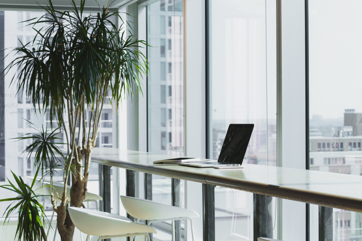 Laptop on desk in serviced office space overlooking the city